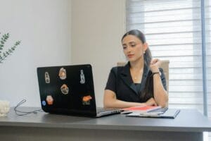 Woman Working On A Laptop At A Desk.