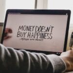 a person writing on a computer screen with a pen