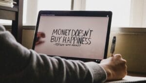 A Person Writing On A Computer Screen With A Pen