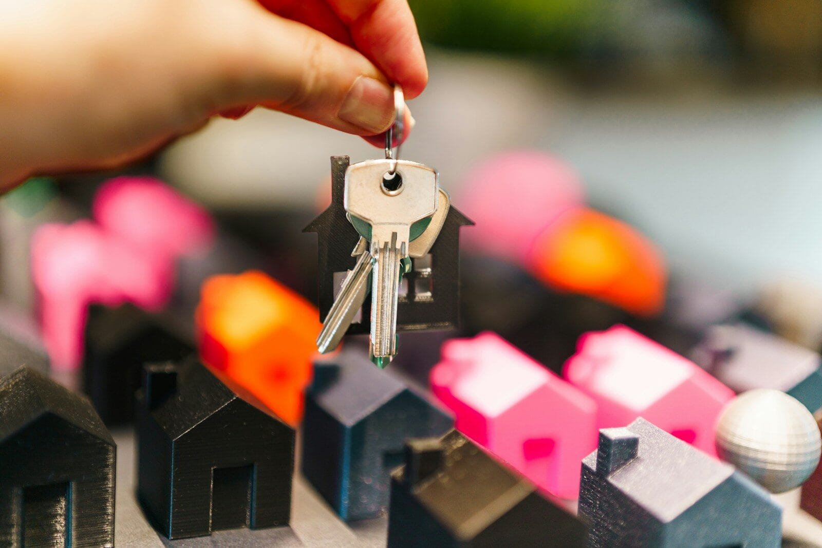 Real Estate Transaction Coordinator Va 1 Hand Holding House Keys Over Miniature Houses